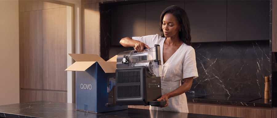 Unboxing a QOVO Q-Slush slushie machine from its box on a kitchen counter